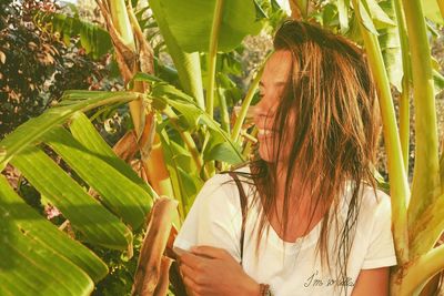 Close-up of young woman by banana tree