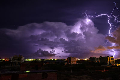 Lightning in sky over city at night