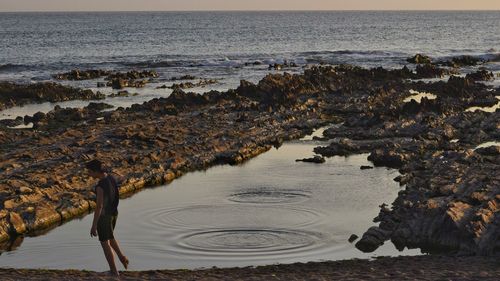 High angle view of beach against sky during sunset