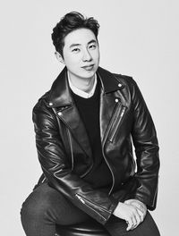 Portrait of young man standing against white background