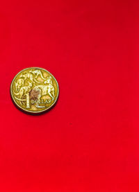 Close-up of coin against red background