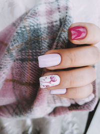 High angle view of woman hand holding pink art