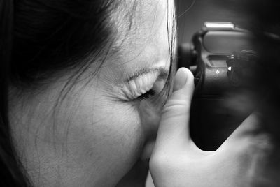 Cropped image of woman photographing
