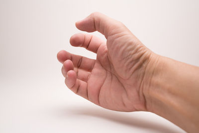 Close-up of hands over white background