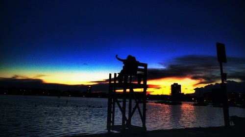 Silhouette of built structure at sunset