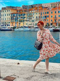 Full length of woman standing against sea