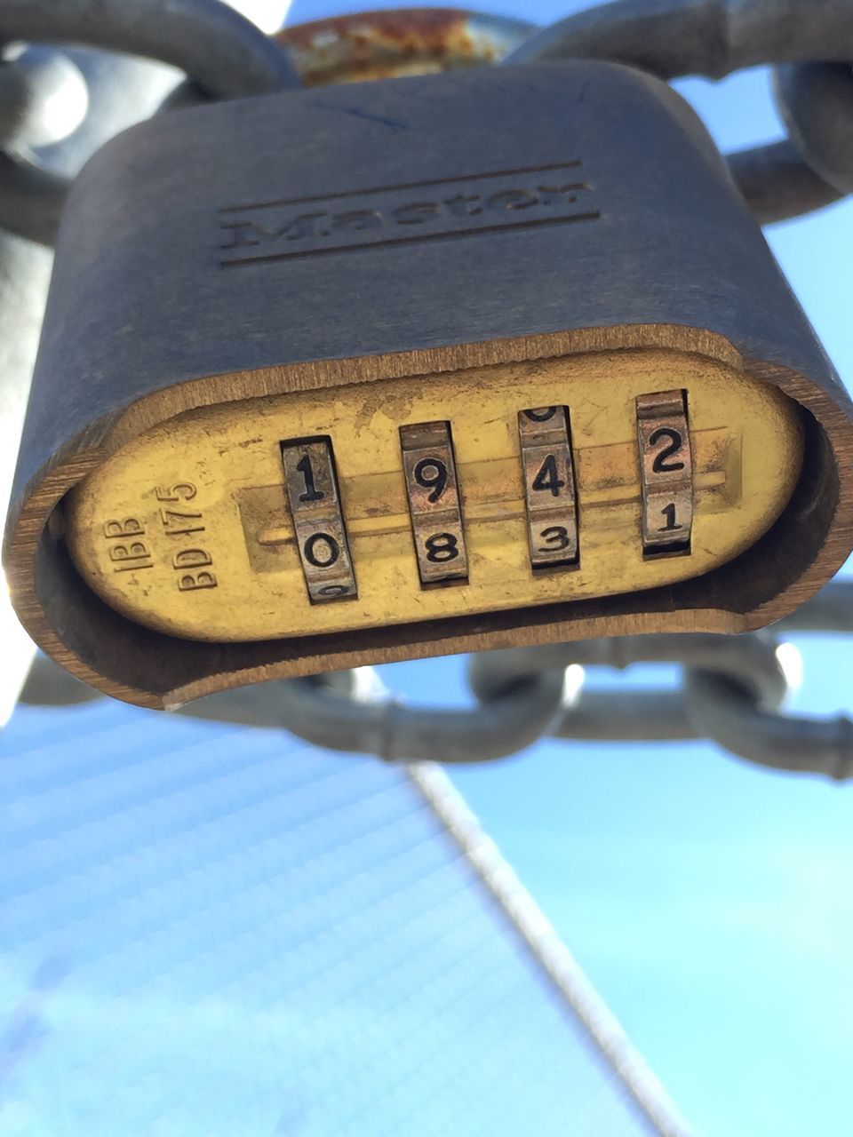 text, close-up, communication, western script, low angle view, metal, focus on foreground, number, part of, sky, guidance, day, metallic, cropped, no people, selective focus, blue, technology, time, outdoors