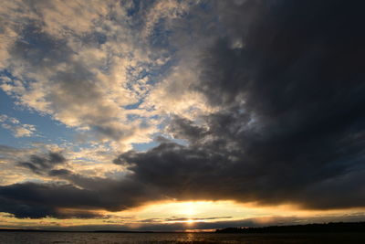 Breakout bright flash of sunlight in the clouds of the sky at sunset