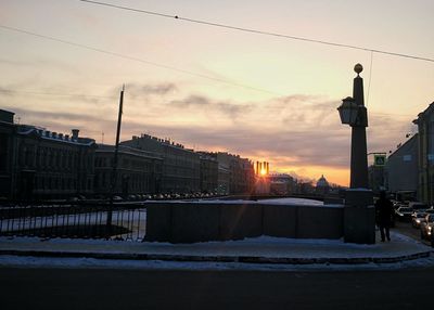 Silhouette city against sky during winter