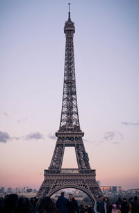 Communications tower in city against sky