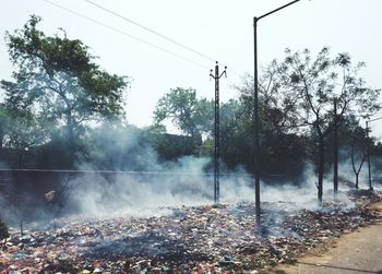Scenic view of burning trash on street