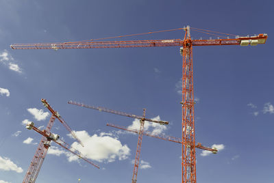 Low angle view of crane against sky