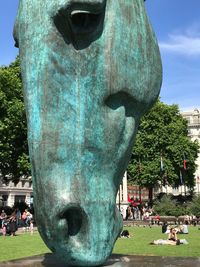 Statue of people in front of building