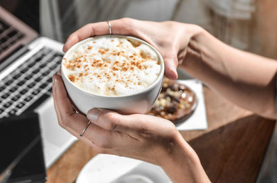 Woman holding coffee cup