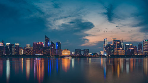 Illuminated city at waterfront