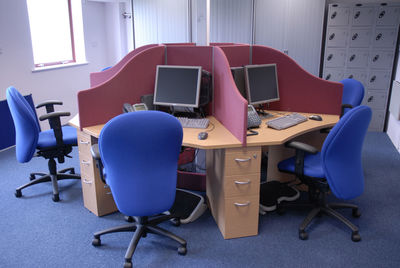 High angle view of chairs and computers in office