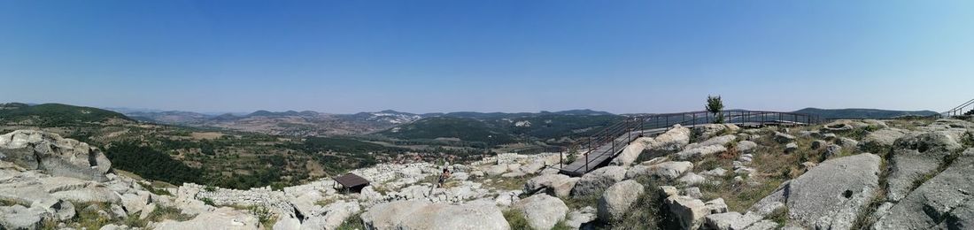 Panoramic view of mountains against clear blue sky