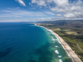 Aerial drone view of lagoons beach conservation area and a3 tasman highway, east coast of tasmania