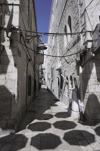 Walkway amidst buildings in city