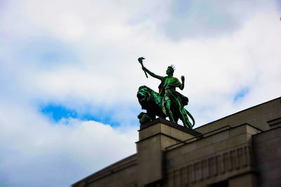 Low angle view of statue against cloudy sky