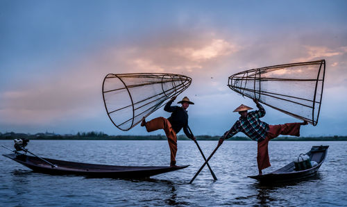 Fishing net in lake against sky