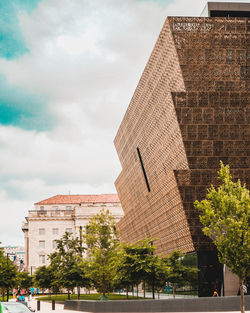 Low angle view of building against cloudy sky