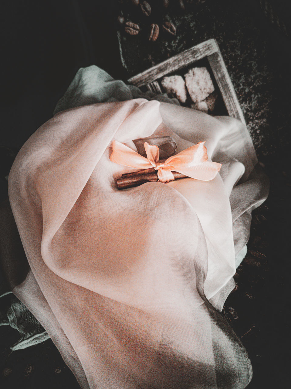 HIGH ANGLE VIEW OF WOMAN HOLDING PAPER WRAPPED IN A CONTAINER