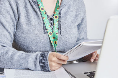 Midsection of woman using laptop