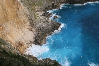 High angle view of cliff by sea