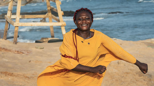 Portrait of smiling young woman on beach