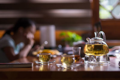 Close-up of woman sitting on table