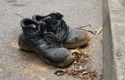 High angle view of black shoes on footpath