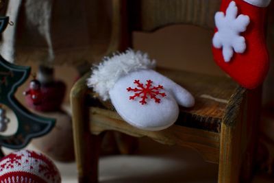 High angle view of white glove on wooden chair