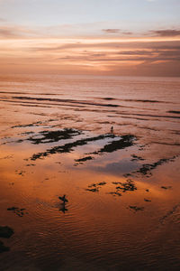 Scenic view of beach against sky during sunset
