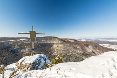 Scenic view of snowcapped mountains against clear blue sky