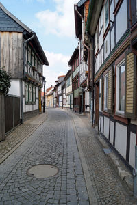 Empty alley amidst buildings in city