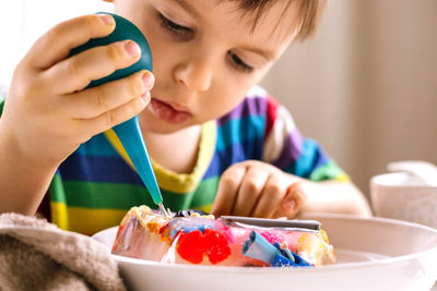 Close up of boy doing craft at home