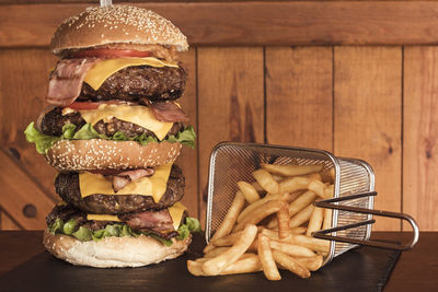 Close-up of burger and cutting board on table