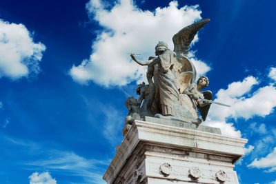 Low angle view of statue against blue sky