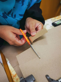 Close up of cutting the braille typed on a piece of paper.