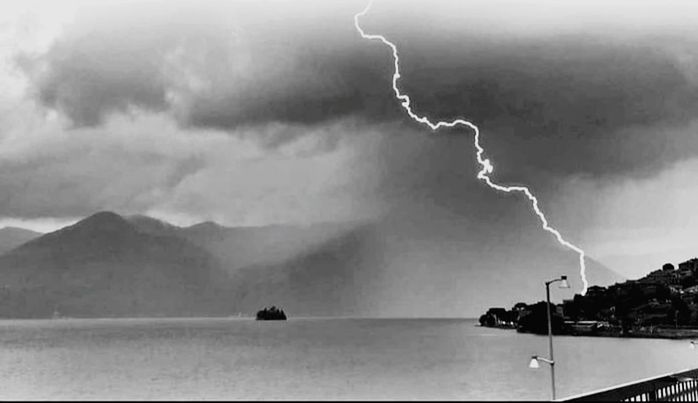 storm, lightning, power in nature, cloud, thunderstorm, black and white, beauty in nature, sky, warning sign, thunder, sign, environment, water, storm cloud, nature, communication, scenics - nature, electricity, monochrome photography, monochrome, dramatic sky, mountain, no people, outdoors, extreme weather, forked lightning, overcast, landscape, wet, rain, violence