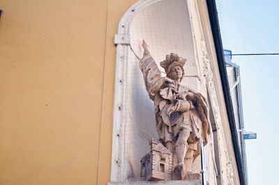 Low angle view of statue against building