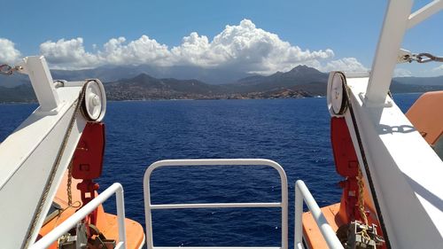 Close-up of boat sailing on sea against sky