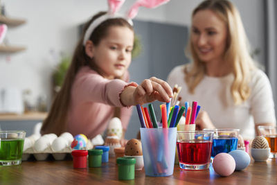 Mother and daughter decorating easter egg