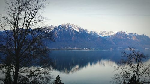 Scenic view of lake and mountains against sky