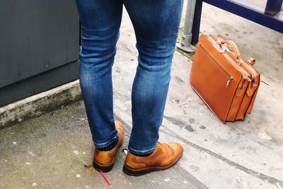 Low section of man standing on footpath