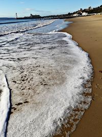 Close-up of beach against sky