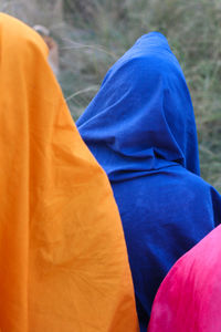 Rear view of woman standing against blue sea