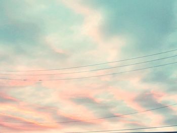 Low angle view of power lines against sky