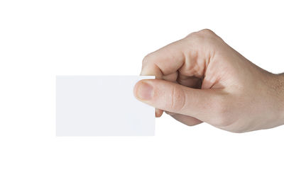 Midsection of person holding paper against white background